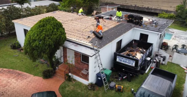 at work repairing Commercial Roofing Contractor in Miami Dade Fla