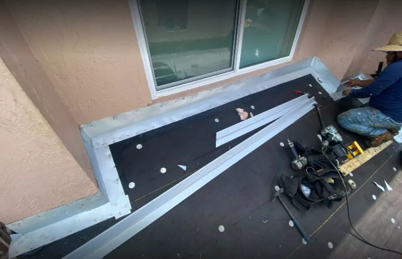 Flat roof repair Miami — roofing technician inspecting membrane